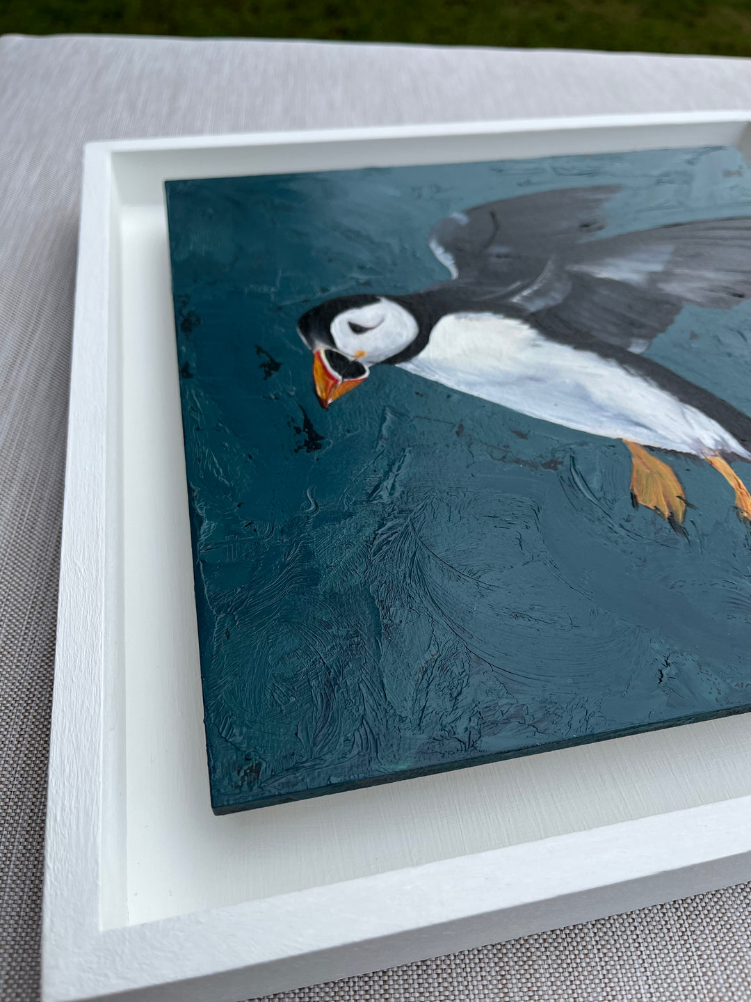 angled image from the left, to see the painting framed in a white floating frame