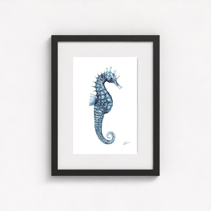 seahorse print on wall in black frame  on white wall
