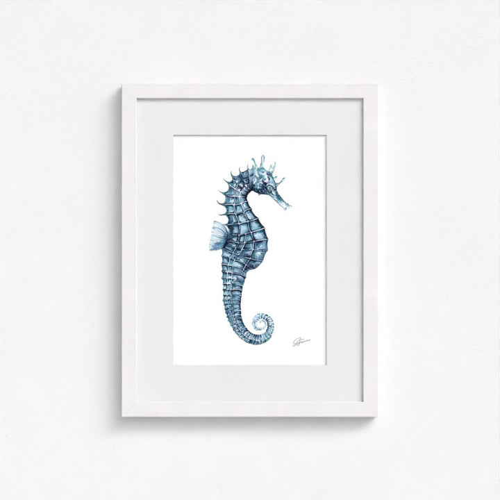 seahorse print on wall in white frame  on white wall