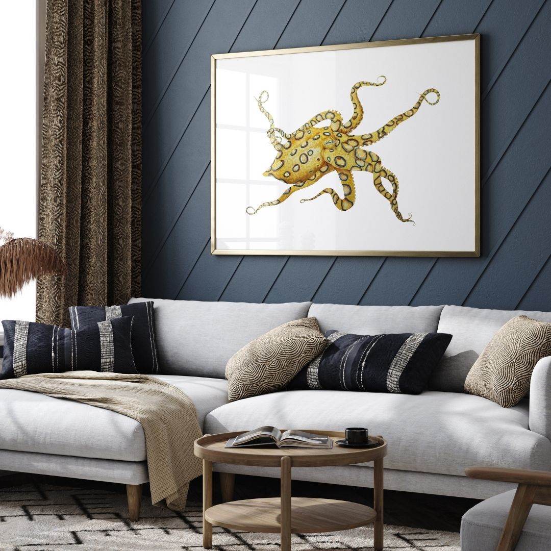 Living room with a gray sofa, wooden coffee table, and framed octopus art on a blue wall.