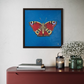 peacock on wall in black frame