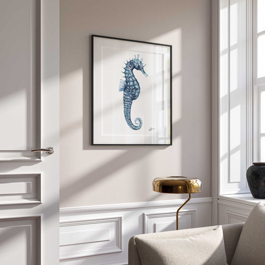 seahorse print on wall in black frame  on white wall