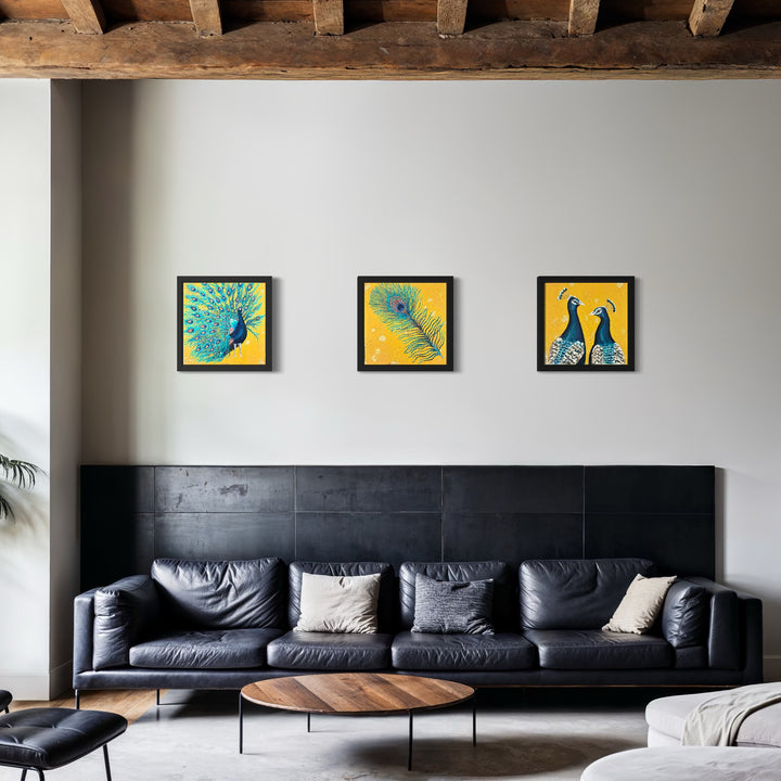 Living room with a black sofa, wooden coffee table, and three peacock feather paintings on the wall.
