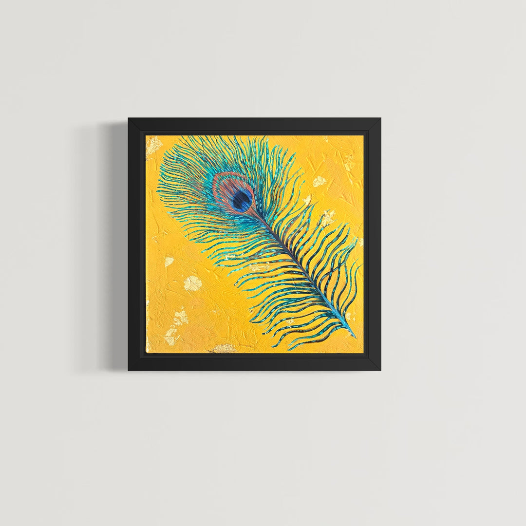 Framed artwork of a peacock feather on a yellow background