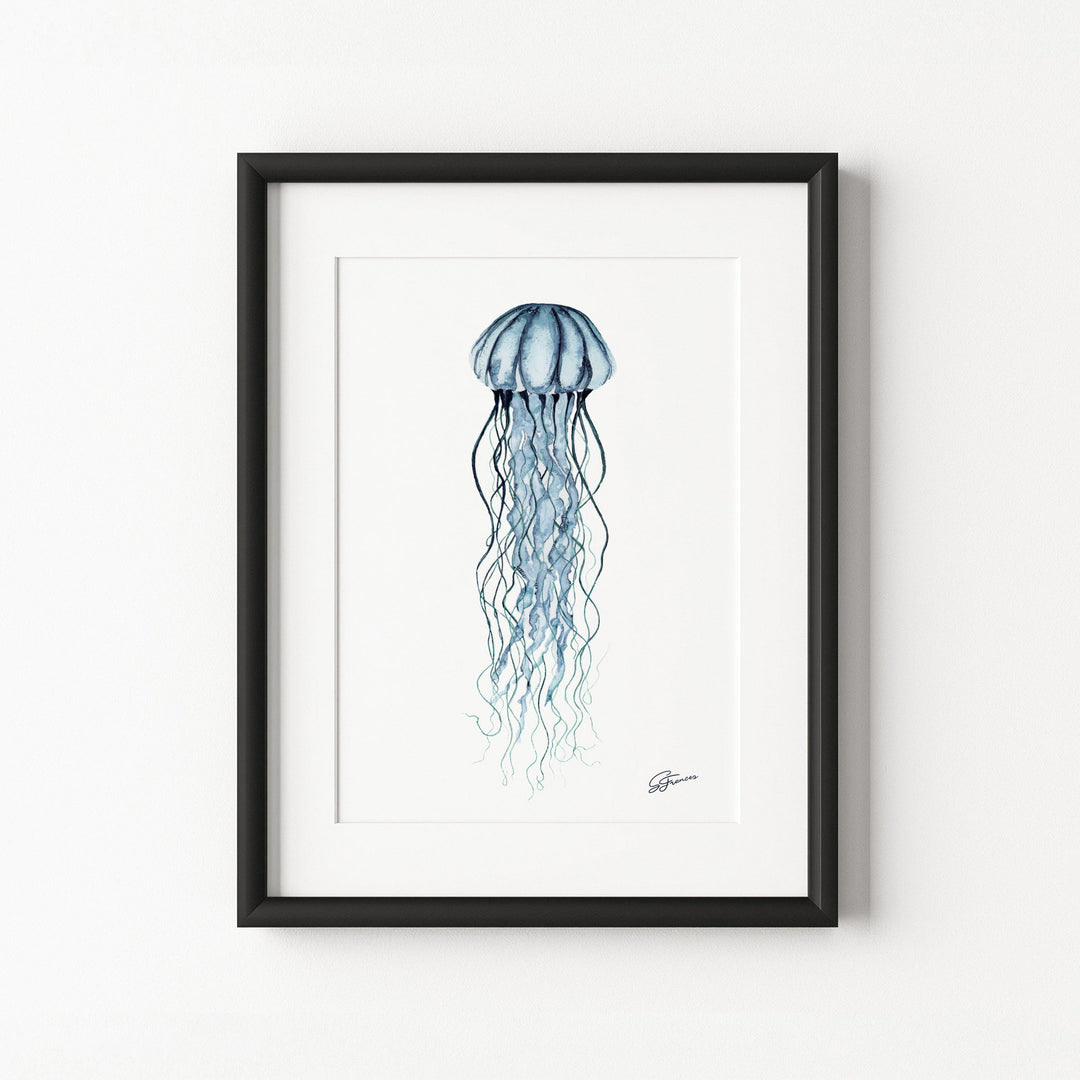 Framed artwork of a jellyfish on a white wall