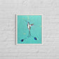 humming bird painting on a dusty green hue canvas , in a white frame on a white brick wall