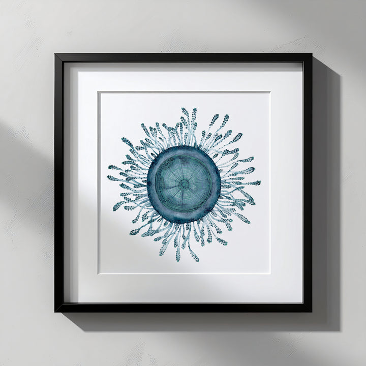 Framed artwork of a blue circular design with patterns on a white background