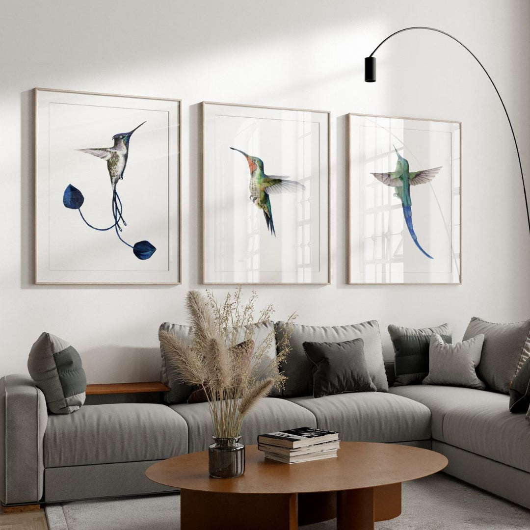 Living room with a gray sectional sofa, wooden coffee table, and wall art of hummingbirds.