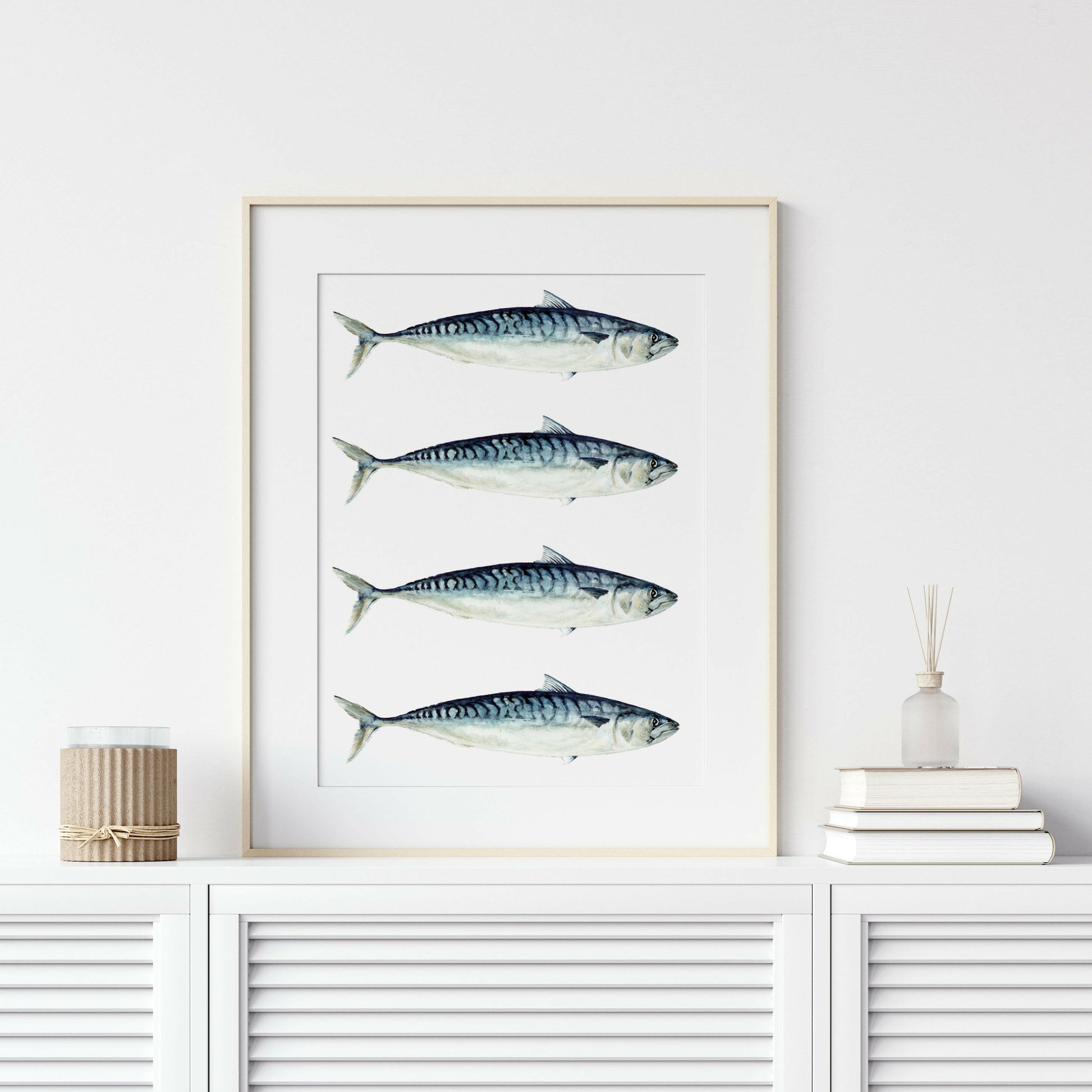 4 Mackerels  in portrait, white background, light wood frame, on a white  shelf with a  wall