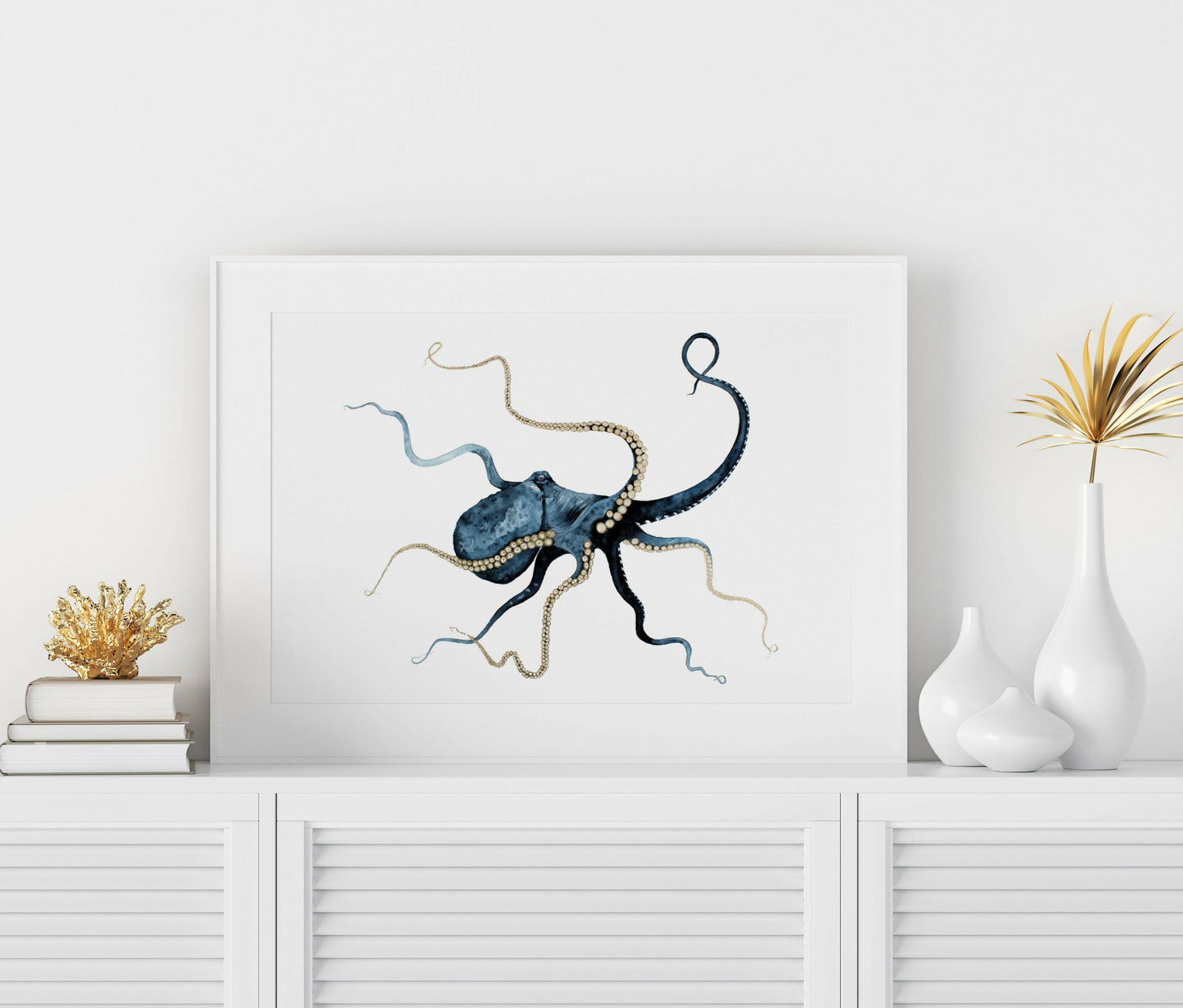 blue octopus watercolour , gold embellishment framed in white on a white  shelf